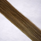 Luxury Remy human hair extension shade swatch in Almond #9 from the Remalisse Studio Collection, featuring a soft neutral dark blonde tone with muted beige undertones, subtle dimension, a silky finish, and natural shine.