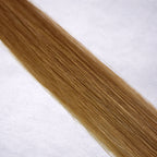 Luxury Remy human hair extension shade swatch in Butternut #8 from the Remalisse Studio Collection, featuring a warm dark blonde tone with golden caramel undertones, soft dimension, a silky finish, and natural shine.