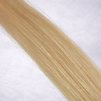 Luxury Remy human hair extension shade swatch in Cashmere #24 from the Remalisse Studio Collection, featuring a soft light blonde tone with cool creamy undertones, subtle dimension, a silky finish, and natural shine.

