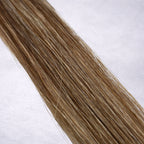 Studio Collection shade swatch in Chocolate Caramel Twist #M14/18, featuring a dimensional blend of rich chocolate brunette and warm wheat blonde tones with soft caramel ribboned highlights, a silky finish, and natural shine.