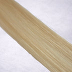 Luxury Remy human hair extension shade swatch in Creamy Blonde #613 from the Remalisse Studio Collection, featuring a warm light blonde tone with creamy golden undertones, soft dimension, a silky finish, and natural shine.
