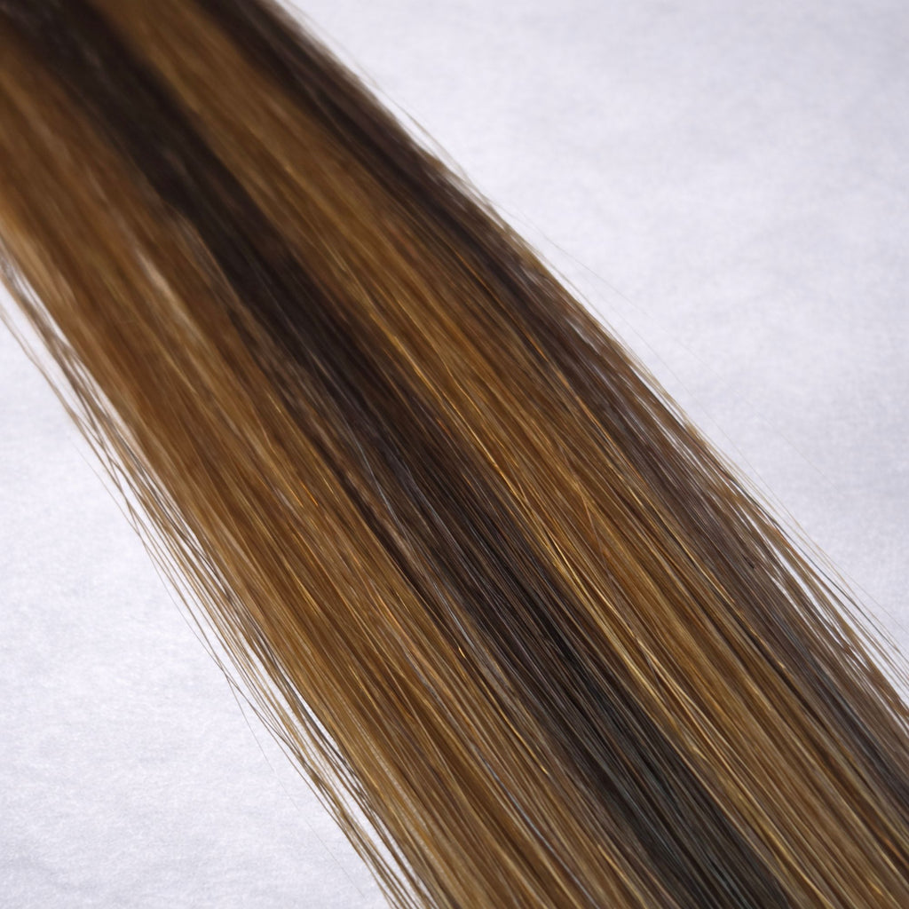 Studio Collection shade swatch in Espresso Twist #P2/6, featuring a dimensional blend of rich espresso brunette and warm chestnut brown tones with soft ribboned highlights, displayed with a smooth silky finish and natural shine.