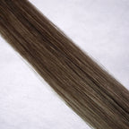 Luxury Remy human hair extension shade swatch in Hazelnut Ash #7, featuring a muted medium brown tone with cool ash undertones, soft dimension, a silky finish, and natural shine.