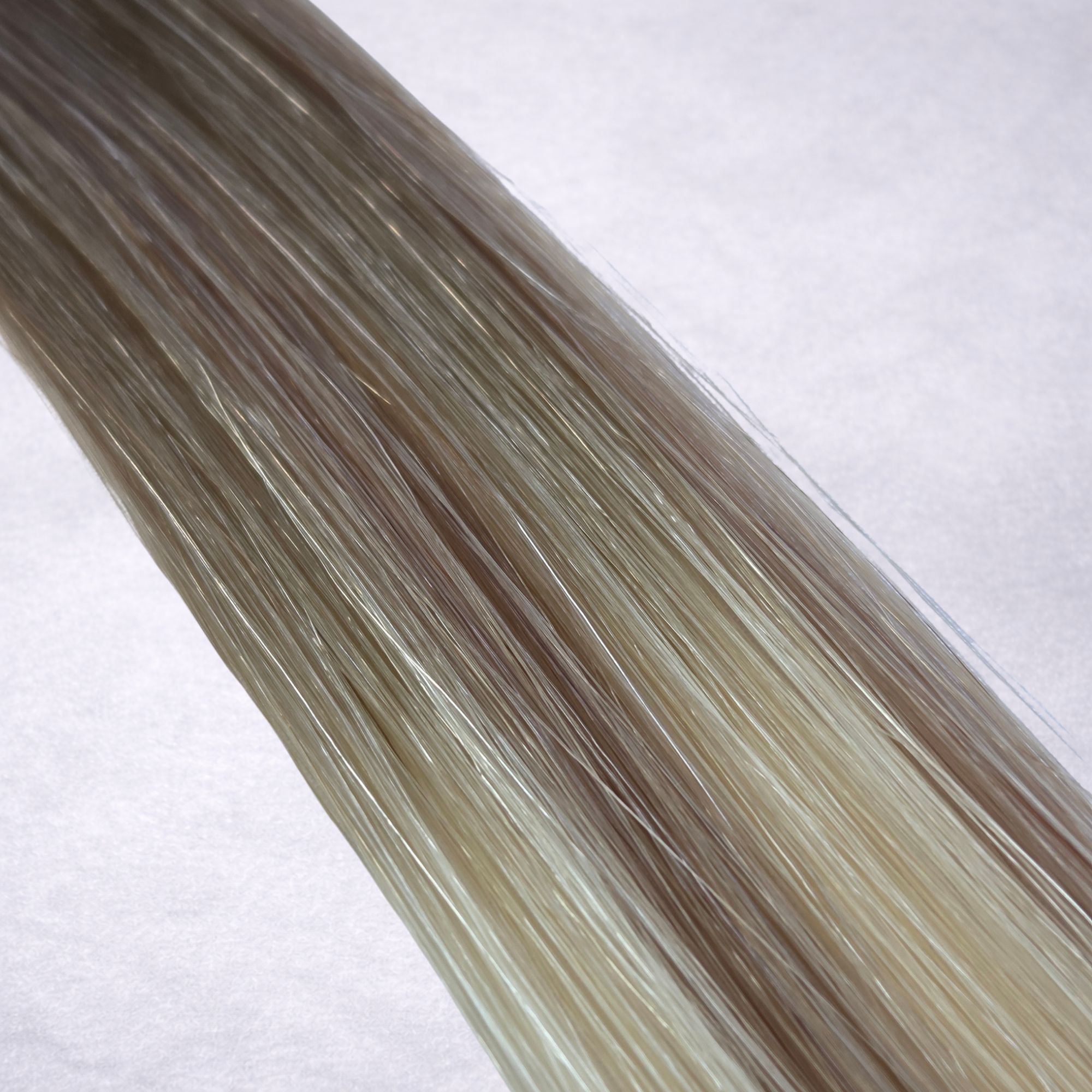 Studio Collection shade swatch in Hollywood Blonde #B7A/60, featuring a dimensional blend of cool mushroom blonde and creamy vanilla blonde tones with bright ribboned highlights, a silky finish, and natural shine.