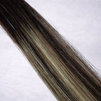 Studio Collection shade swatch in Iced Bronde #B2/22, featuring a dimensional blend of rich espresso brunette and soft honey blonde tones with cool bronde ribboned highlights, a silky finish, and natural shine.