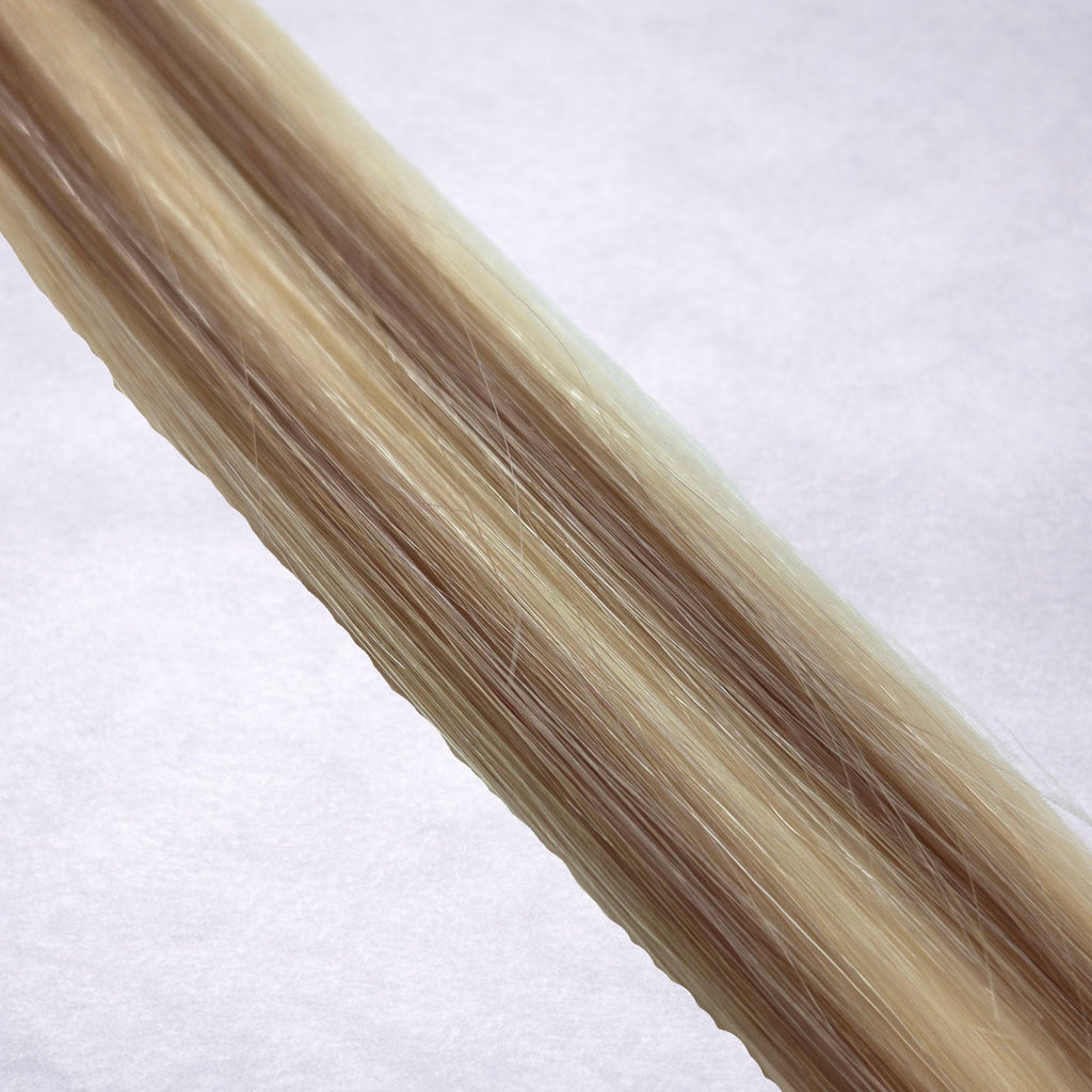 Studio Collection shade swatch in Iced Truffle #P613/10, featuring a dimensional blend of creamy blonde and soft petal blonde tones with cool beige ribboned highlights, a silky finish, and natural shine.