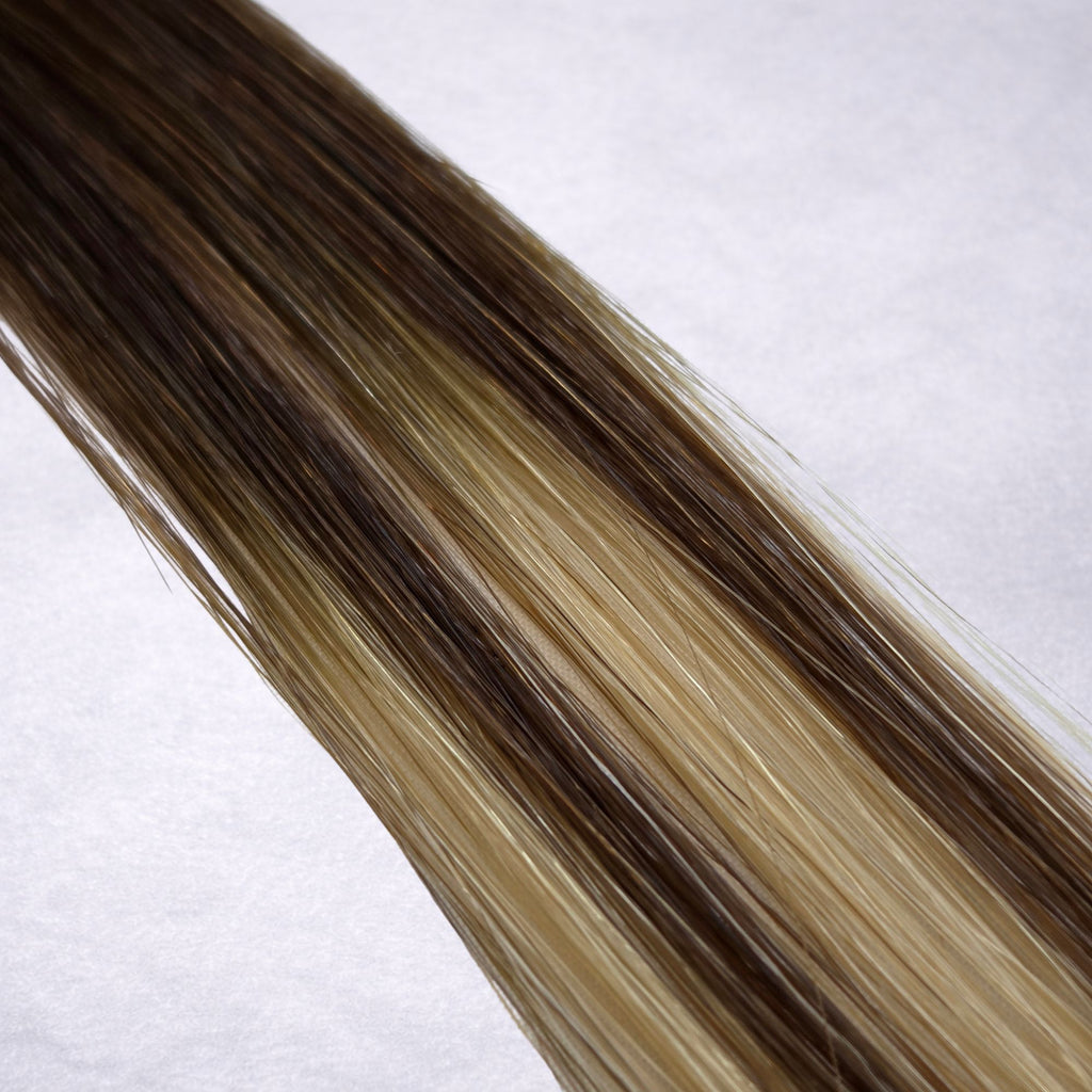 Studio Collection shade swatch in Mocha Melt #B4/18, featuring a dimensional blend of rich chocolate brunette and soft wheat blonde tones with smoky mocha ribboned highlights, a silky finish, and natural shine.