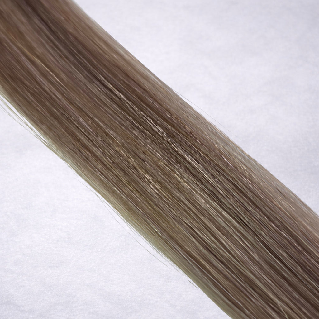 Luxury Remy human hair extension shade swatch in Mushroom #7A from the Remalisse Studio Collection, featuring a cool dark blonde tone with smoky ash undertones, soft dimension, a silky finish, and natural shine.