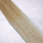 Studio Collection shade swatch in Oatmilk Melt #T18/60A, featuring a dimensional blend of soft wheat blonde roots melting into cool oatmilk blonde lengths with creamy ash tones, a silky finish, and natural shine.