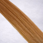 Luxury Remy human hair extension shade swatch in Strawberry Blonde #27 from the Remalisse Studio Collection, featuring a warm copper blonde tone with soft rosy-golden undertones, natural dimension, a silky finish, and natural shine.