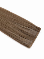 Studio Collection injection tape-in hair extension in a cool taupe blonde shade, featuring soft ash-beige undertones, an ultra-discreet seamless injection tab, silky straight Remy human hair, and a smooth natural finish against a clean white background.