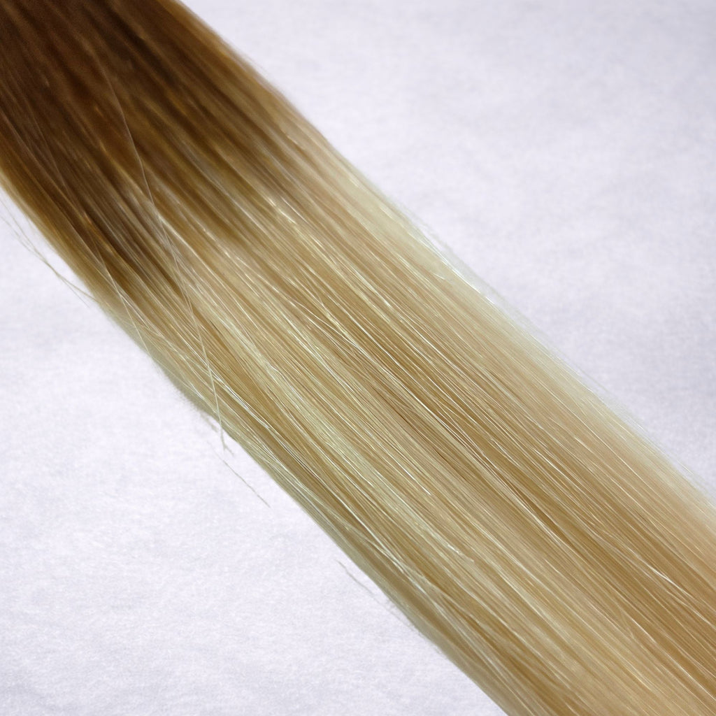 Studio Collection shade swatch in Sun-Kissed Cream #T6/613, featuring a dimensional blend of warm chestnut brown roots and creamy blonde lengths with soft golden balayage tones, a silky finish, and natural shine.