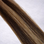 Studio Collection shade swatch in Truffle Waves #P4/10, featuring a dimensional blend of rich chocolate brunette and soft petal blonde tones with cool truffle-inspired ribboned highlights, a silky finish, and natural shine.