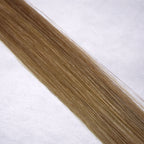 Luxury Remy human hair extension shade swatch in Warm Beige #12 from the Remalisse Studio Collection, featuring a warm dark blonde tone with soft beige undertones, natural dimension, a silky finish, and natural shine.