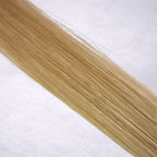 Luxury Remy human hair extension shade swatch in Wheat #18 from the Remalisse Studio Collection, featuring a cool medium blonde tone with soft smoky ash undertones, natural dimension, a silky finish, and natural shine.