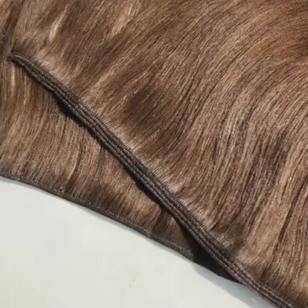 Video close-up of a remalisse volume weft hair extension showing the flexible stitched weft construction, smooth brunette hair texture and natural shine as the hair and seam are moved to demonstrate thickness and flexibility 