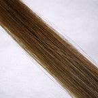 Luxury Remy human hair extension shade swatch in Chestnut #6, featuring a warm medium brown tone with soft golden undertones, glossy depth, a silky finish, and natural shine.
