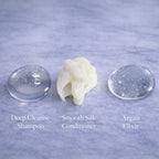 Hair Extension aftercare product textures including Remalisse Shampoo, conditioner and argan oil serum displayed on a marble surface 