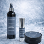 Remalisse rejuvenation mask, silk-restore leave-in conditioner spray, Argan elixir leave in oil serum, displayed together on an icy blue marble background, featuring black bottles with silver accents and blue/grey labels. 