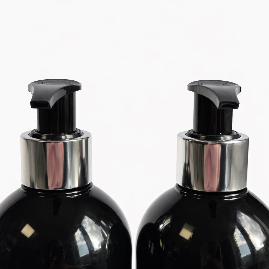 Close-up of Remalisse Shampoo and Conditioner pump bottles showing silver pump detail on black haircare packaging.