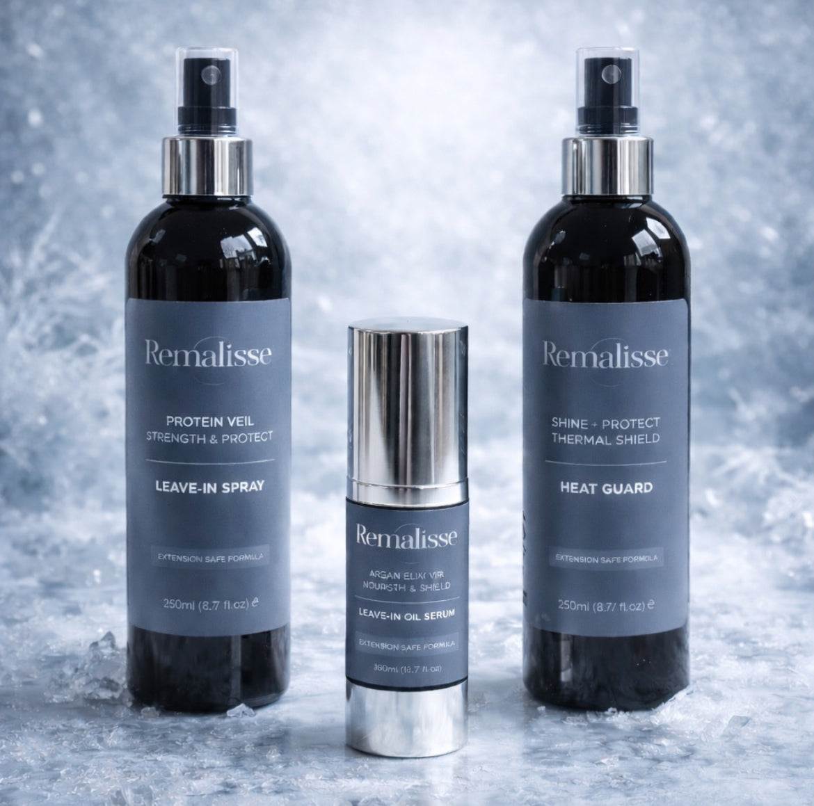 Remalisse hair extension aftercare products including Shine and Protect heat guard, protein veil leave-in spray- argan elixir oil serum displayed together on a textured icy blue background. 