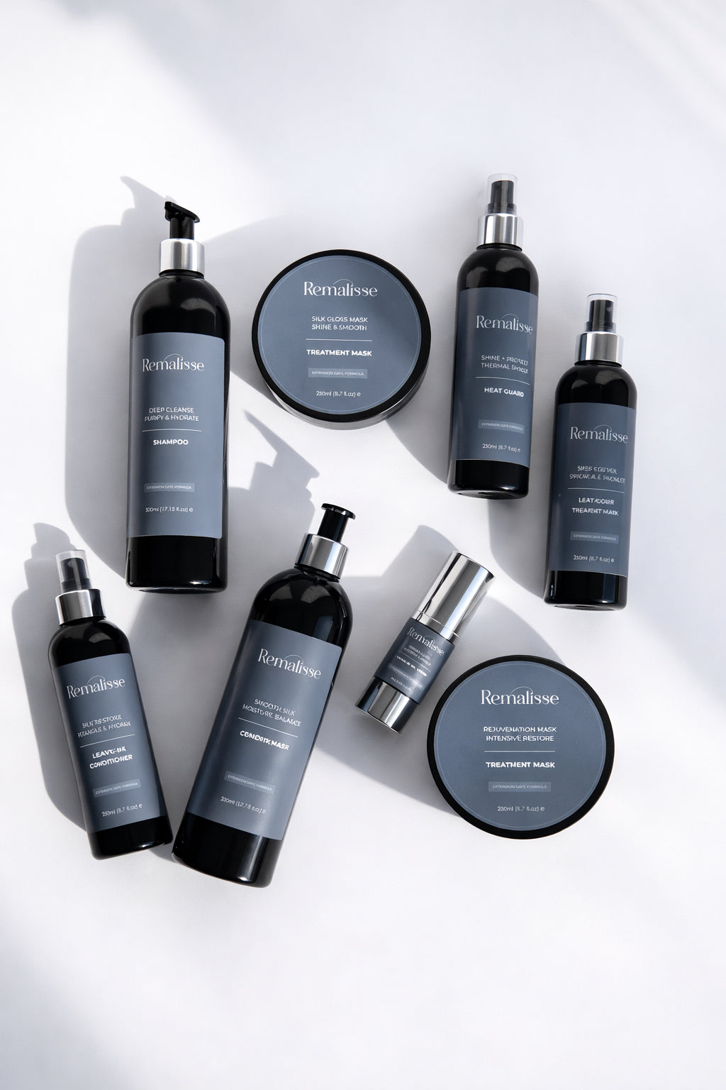 Remalisse hair extension aftercare collection including deep cleanse shampoo, smooth silk conditioner, silk gloss mask, rejuvenation mask, heat guard, silk restore leave-in conditioner, protein veil leave-in and argan elixir oil displayed on a white background. 