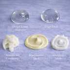 Textures of Remalisse hair extension aftercare products including Deep Cleanse Shampoo, Argan Elixir oil, Smooth Silk Conditioner, Rejuvenation Mask and ilk Gloss Mask displayed on a marble background. 