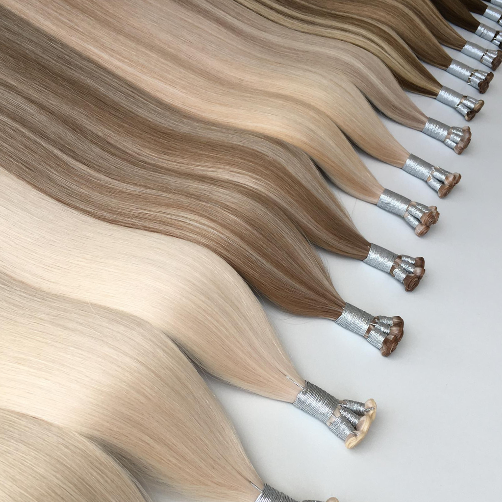 Studio genius weft hair extension bundles in multiple blonde shades with silver wrap on a clean white background