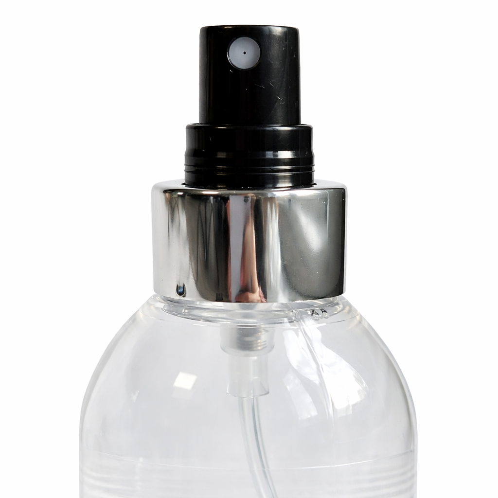Close-up of Remalisse extension remover spray pump and silver collar on a clear bottle against a plain white background. 