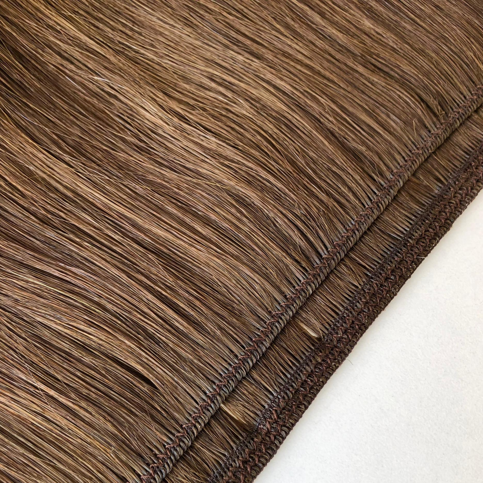 Close-up comparison of a Remalisse volume weft hair extension showing both the underside and outer side of the weft construction, highlighting the stitched seam, hair density and flexible weft design in a brunette shade.